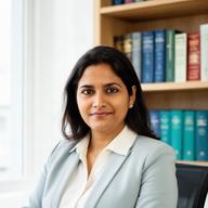 Mukul Saquin, Singapore corporate lawyer, seated in a bright office with legal books behind her